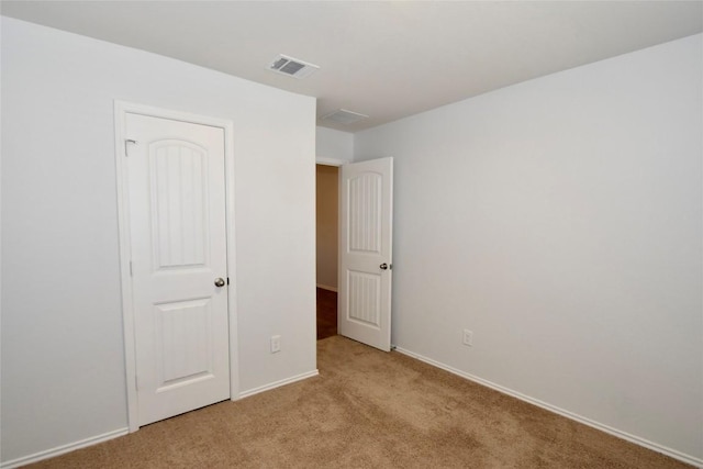 unfurnished bedroom featuring light colored carpet