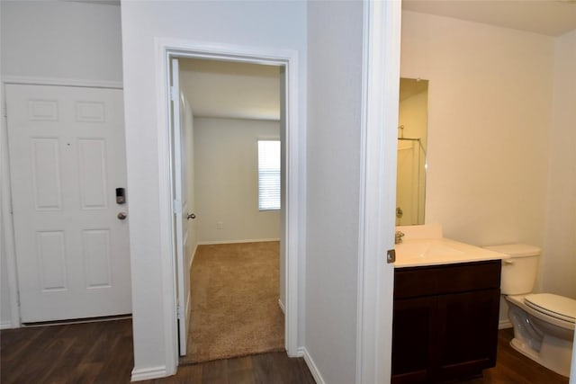 bathroom with vanity, hardwood / wood-style floors, a shower, and toilet