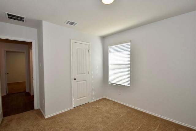 unfurnished bedroom with light carpet and a closet