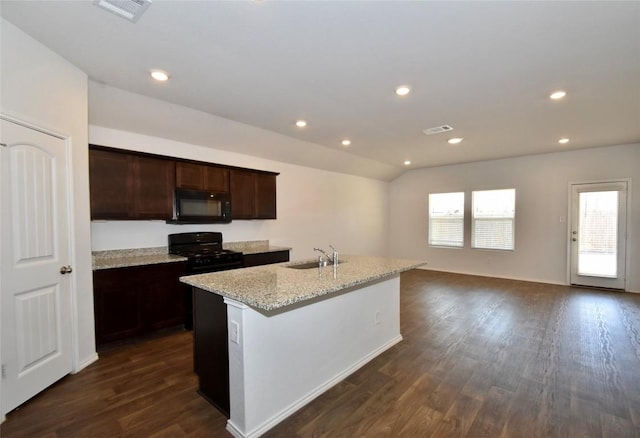 kitchen with a wealth of natural light, sink, a center island with sink, and black appliances