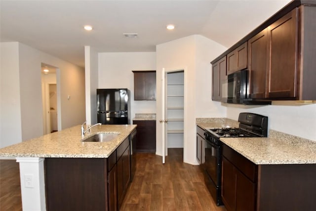 kitchen featuring dark wood-type flooring, sink, dark brown cabinets, and black appliances