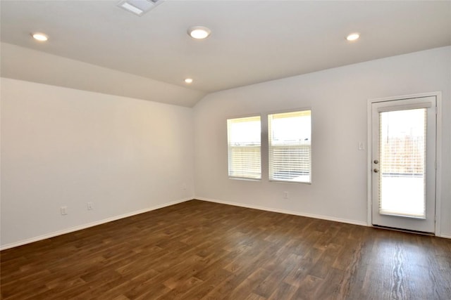 empty room with lofted ceiling and dark hardwood / wood-style floors