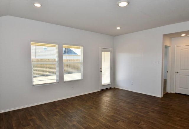 empty room with dark hardwood / wood-style floors