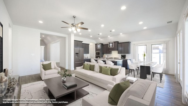 living room featuring visible vents, recessed lighting, baseboards, and wood finished floors