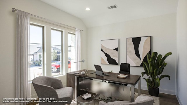 office space with lofted ceiling, plenty of natural light, baseboards, and visible vents