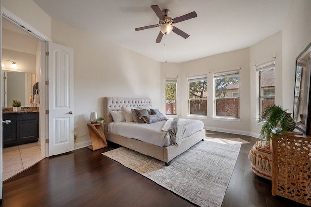 bedroom with dark wood-type flooring, ceiling fan, and ensuite bathroom