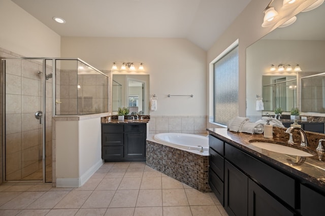 bathroom with lofted ceiling, vanity, tile patterned floors, and separate shower and tub