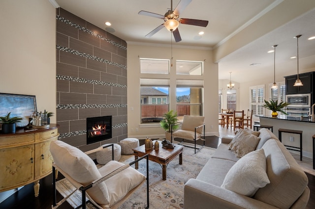 living room with ornamental molding, a fireplace, and a wealth of natural light