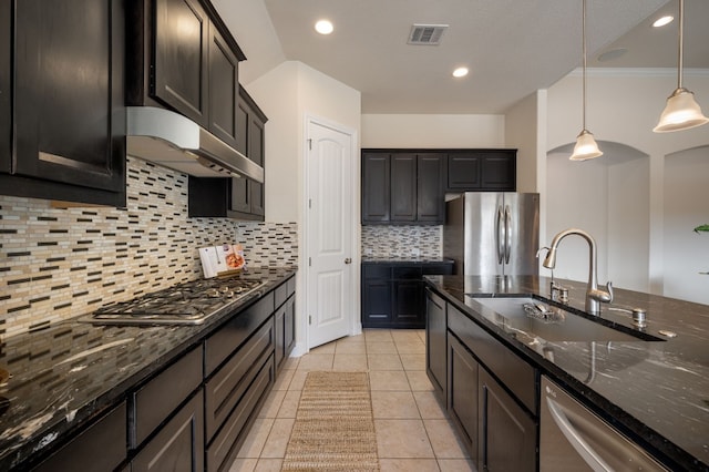 kitchen with pendant lighting, sink, dark stone counters, and appliances with stainless steel finishes