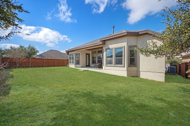 back of house featuring a patio area and a lawn