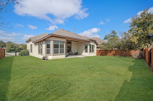 rear view of property featuring a patio area and a lawn