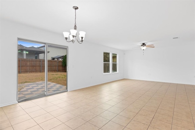 tiled empty room featuring ceiling fan with notable chandelier