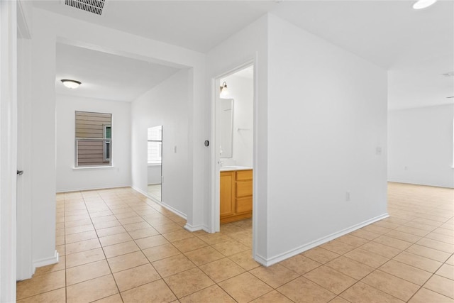 hallway with light tile patterned floors