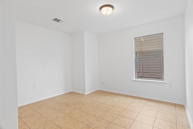 spare room featuring visible vents and baseboards