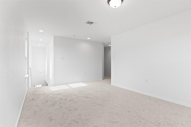 carpeted empty room featuring recessed lighting, visible vents, and baseboards