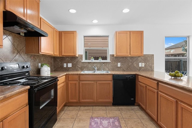 kitchen featuring light tile patterned floors, a sink, decorative backsplash, black appliances, and under cabinet range hood