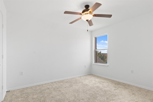 spare room featuring light carpet and ceiling fan