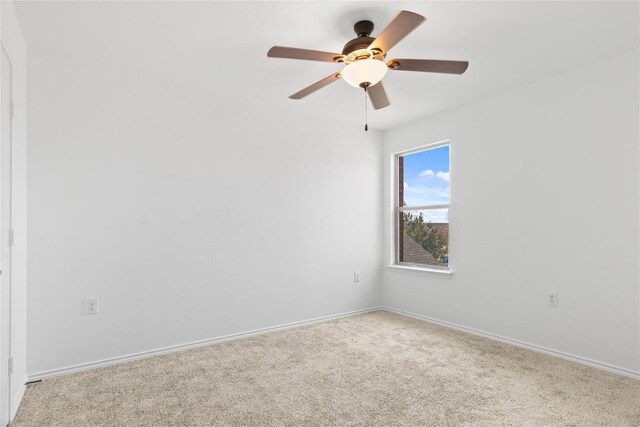 spare room featuring baseboards, carpet floors, and ceiling fan