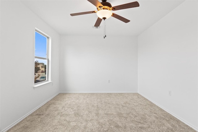 unfurnished room with baseboards, visible vents, carpet floors, and ceiling fan