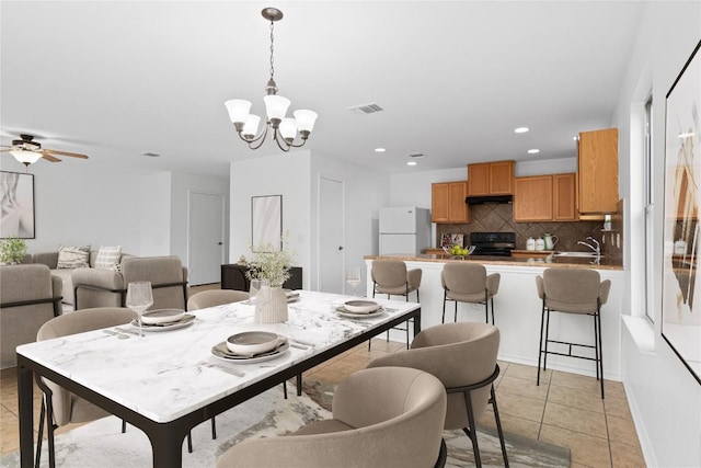 dining area featuring ceiling fan with notable chandelier, light tile patterned flooring, recessed lighting, and visible vents