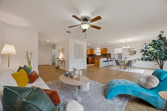 11009 Roderick Lawson Ln, Austin, TX 78754 - living area featuring light tile patterned floors, a ceiling fan, a chandelier, recessed lighting, and baseboards