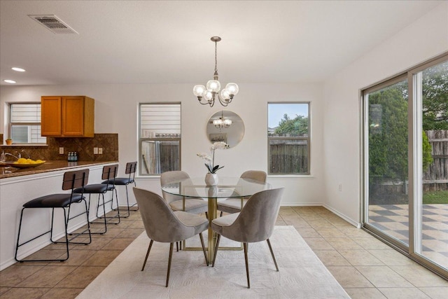 11009 Roderick Lawson Ln, Austin, TX 78754 - dining space with light tile patterned floors, a chandelier, recessed lighting, and baseboards