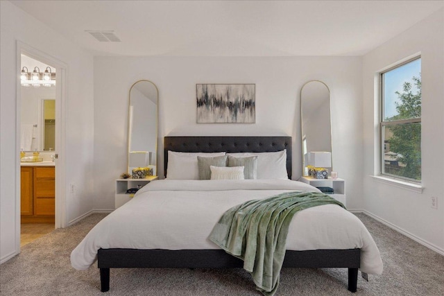 11009 Roderick Lawson Ln, Austin, TX 78754 - bedroom featuring light carpet, ensuite bath, and baseboards
