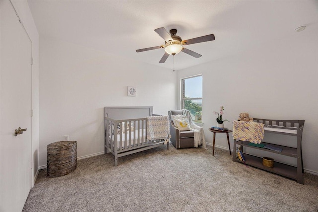 11009 Roderick Lawson Ln, Austin, TX 78754 - carpeted bedroom featuring a nursery area, ceiling fan, and baseboards