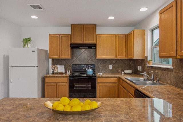 11009 Roderick Lawson Ln, Austin, TX 78754 - kitchen featuring freestanding refrigerator, black electric range, under cabinet range hood, tasteful backsplash, and recessed lighting
