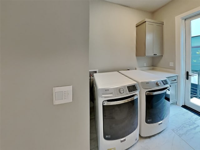 laundry room featuring independent washer and dryer and cabinets