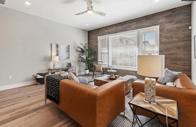 living room with ceiling fan and light hardwood / wood-style floors