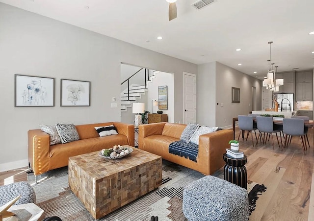 living room featuring light hardwood / wood-style flooring and a chandelier