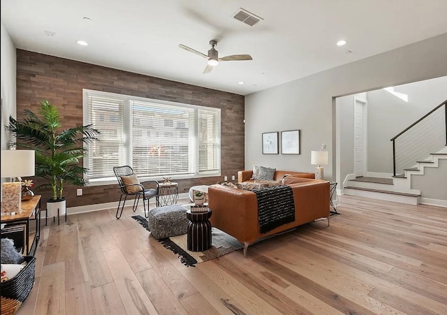 living room with ceiling fan and light wood-type flooring