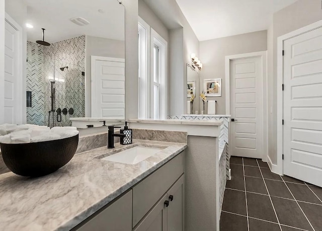 bathroom with an enclosed shower, vanity, and tile patterned floors