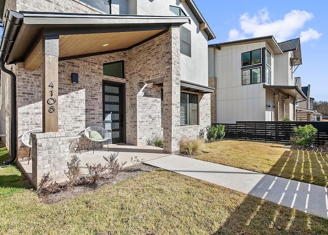 entrance to property with a lawn