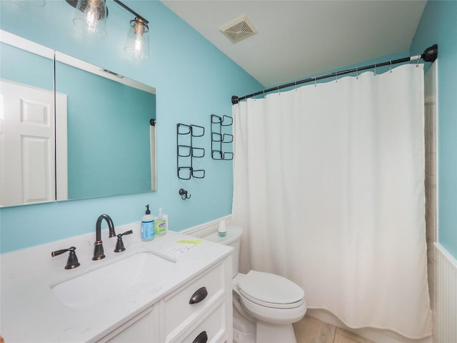 bathroom featuring vanity, tile patterned flooring, toilet, and walk in shower