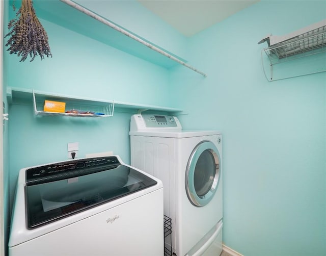 clothes washing area featuring washing machine and clothes dryer