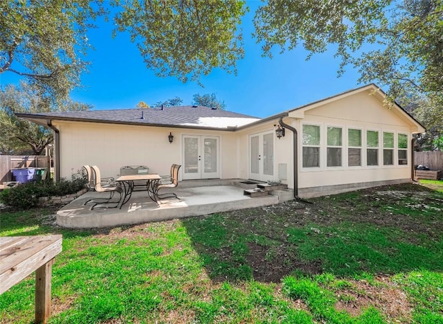 back of property featuring french doors, a yard, and a patio