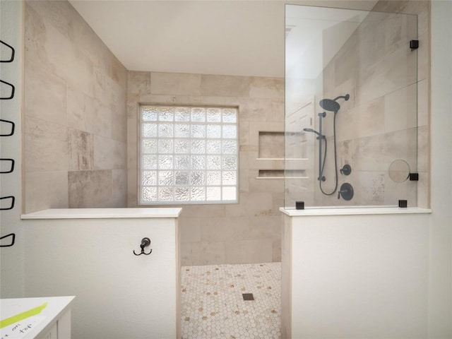 bathroom with a tile shower