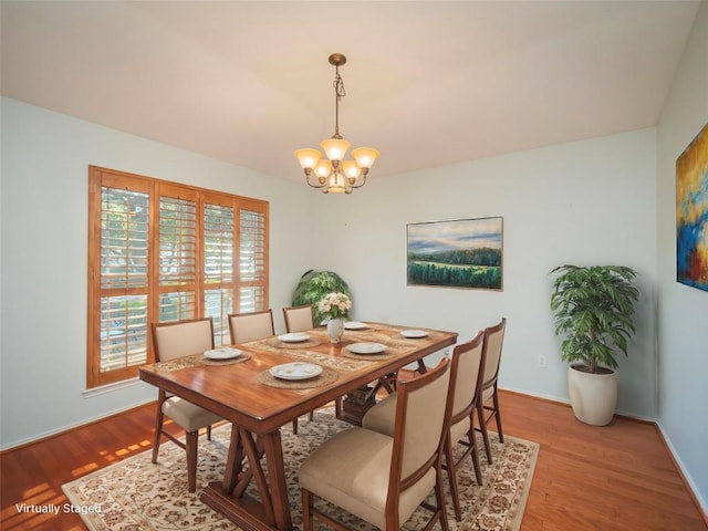 dining room featuring an inviting chandelier and light hardwood / wood-style flooring