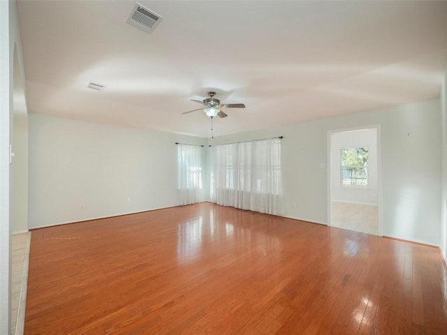 empty room featuring ceiling fan and light hardwood / wood-style floors