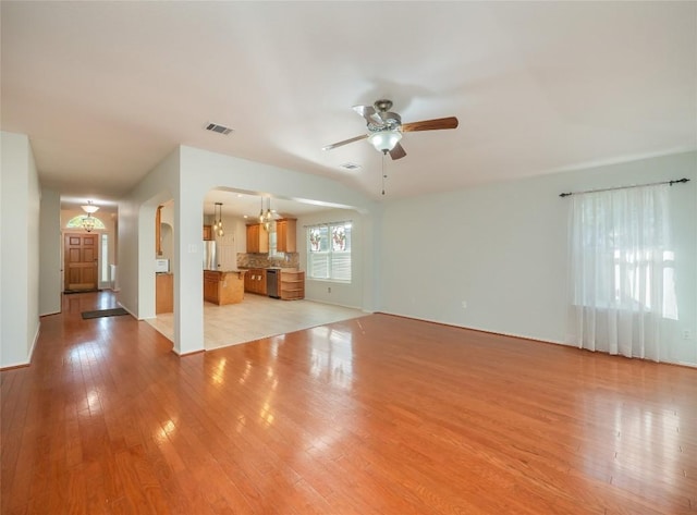 unfurnished living room featuring ceiling fan and light hardwood / wood-style flooring