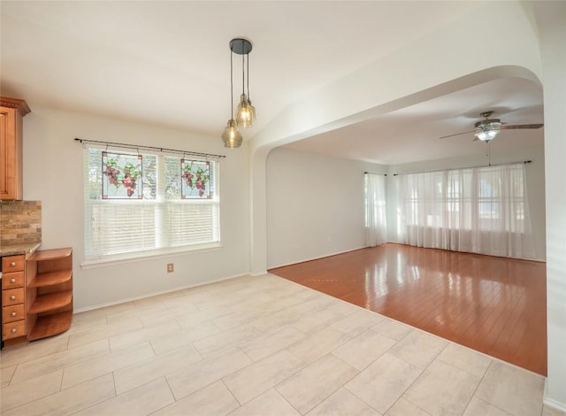 interior space featuring lofted ceiling, ceiling fan, and light wood-type flooring