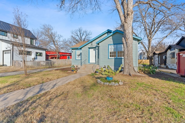 bungalow-style home featuring a front yard