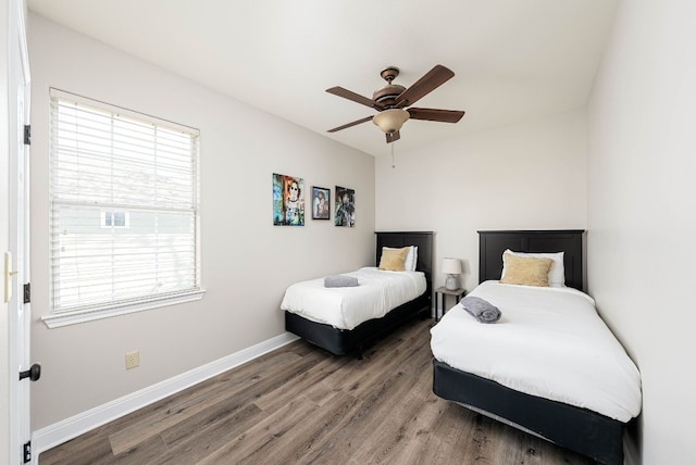 bedroom featuring multiple windows, hardwood / wood-style floors, and ceiling fan