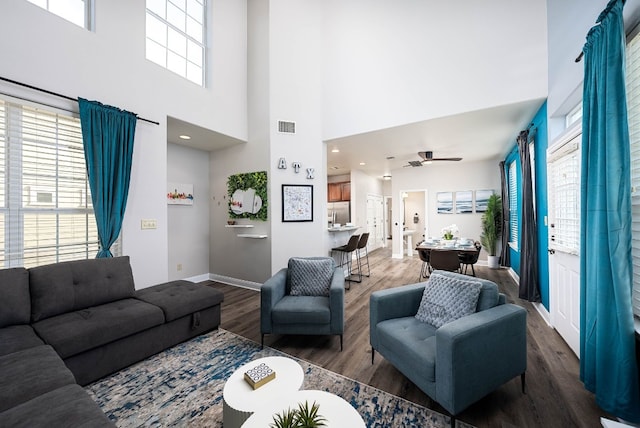 living room featuring wood-type flooring and ceiling fan