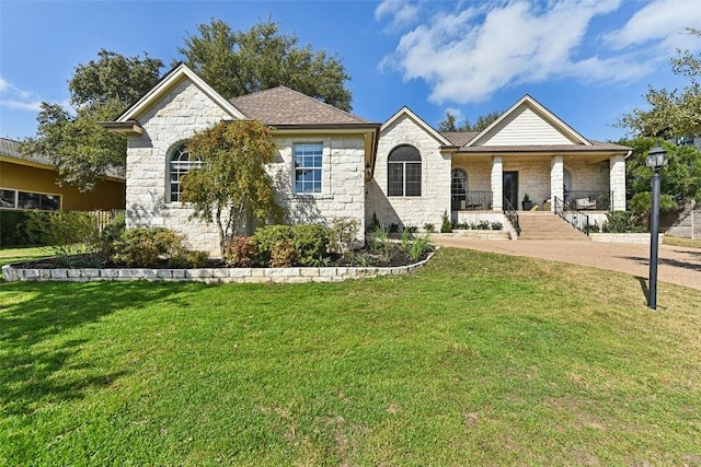 view of front of house with a porch and a front lawn