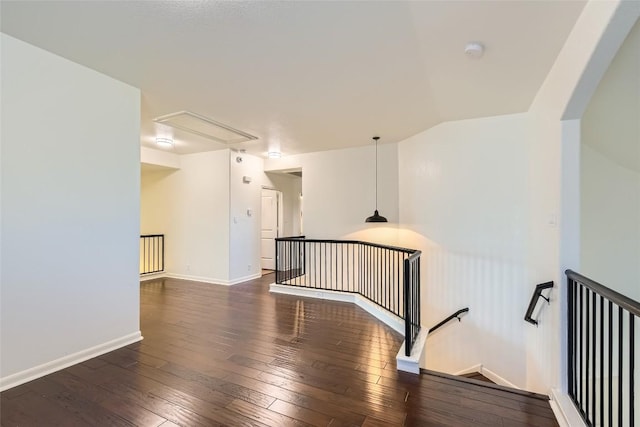 unfurnished room with dark wood-type flooring and lofted ceiling