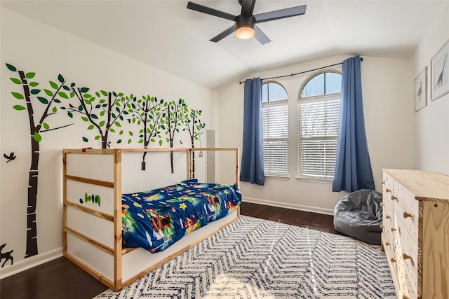 bedroom with dark hardwood / wood-style flooring, vaulted ceiling, and ceiling fan