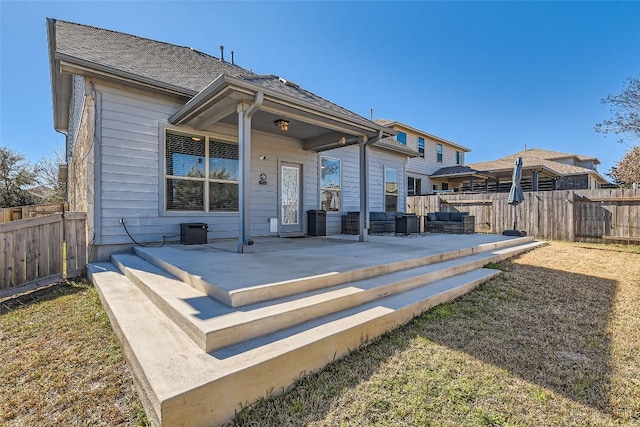 back of property featuring an outdoor living space and a patio area